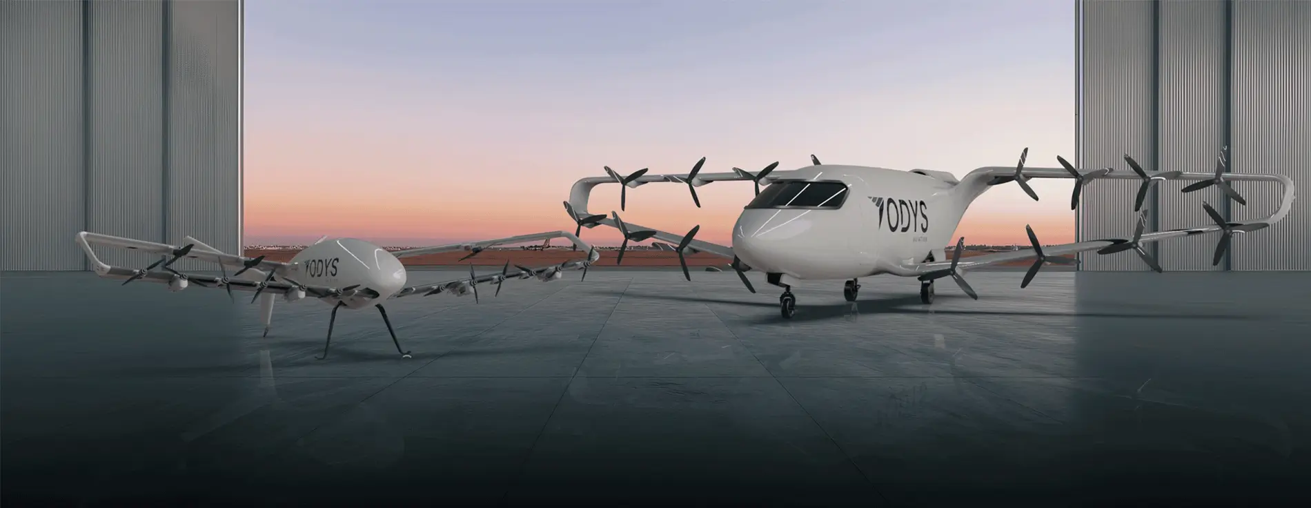 Two electric aircraft with multiple propellers parked on a runway at sunset.