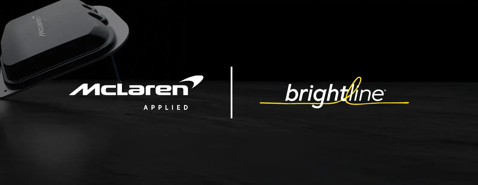 Dark promotional graphic showing a compact electronic device alongside the McLaren Applied logo on the left and the Brightline logo on the right, displayed on a black background.