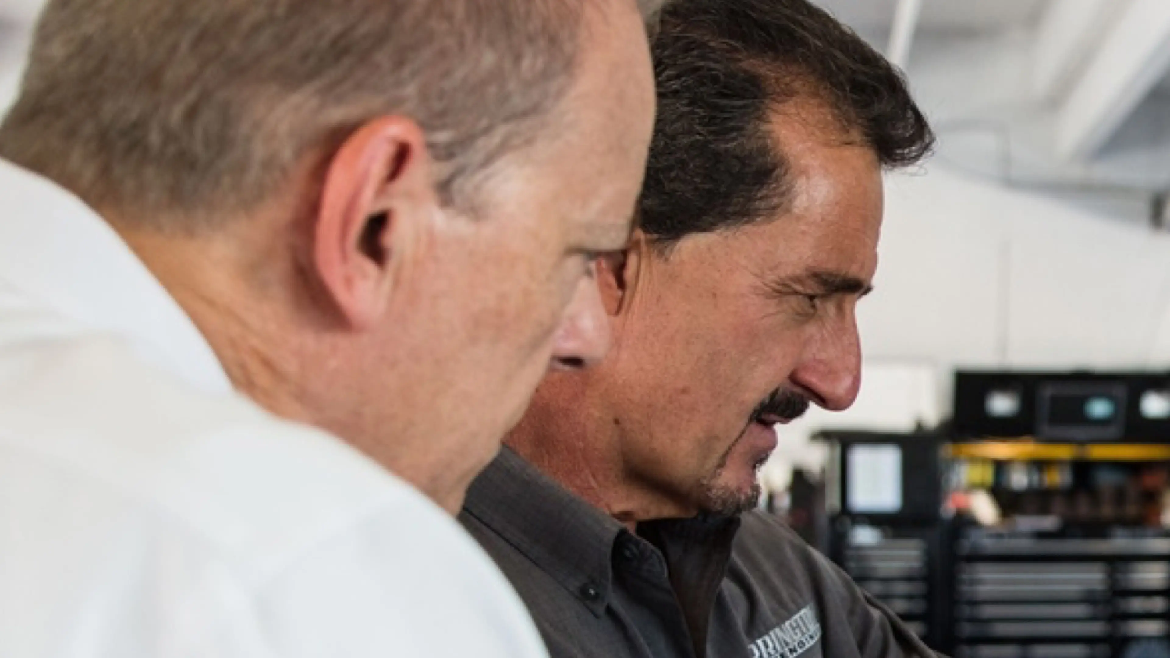 Two people looking at a monitor